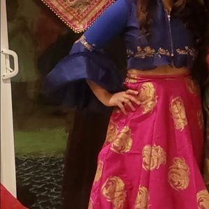 Long pink skirt with blue zip top.